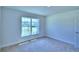 Spacious bedroom with large window and carpet flooring at 1261 Tagliamento Ln, Haines City, FL 33844