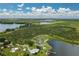 Aerial view showcasing waterfront home surrounded by lush citrus grove at 1702 Parks Lake Rd, Lake Wales, FL 33898