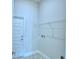 Bright laundry room with built-in shelving and tile flooring at 502 Tanaro Ln, Haines City, FL 33844