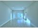 Bright and airy living room with tile flooring and access to backyard at 502 Tanaro Ln, Haines City, FL 33844