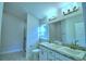 Bathroom with double vanity, shower, and toilet at 502 Tanaro Ln, Haines City, FL 33844