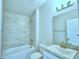 Small bathroom with single vanity and tub at 502 Tanaro Ln, Haines City, FL 33844