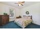 Bedroom with a striped comforter and dark wood dresser at 9011 Whipperwill Ln, Haines City, FL 33844