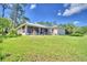 House with a screened porch, patio furniture, and fire pit at 1955 W Lake Hamilton Dr, Winter Haven, FL 33881