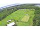 Aerial view of a large property with barns and a fenced area at 1955 W Lake Hamilton Dr, Winter Haven, FL 33881