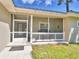 Front porch with white railing and screen door at 1955 W Lake Hamilton Dr, Winter Haven, FL 33881
