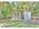Outdoor dog kennel with chain link and wooden structure at 1955 W Lake Hamilton Dr, Winter Haven, FL 33881