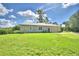 Single story house with metal roof and attached garage at 1955 W Lake Hamilton Dr, Winter Haven, FL 33881