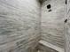 Walk-in shower with wood-look tile and built-in bench seating at 1793 Lakehill Dr, Winter Haven, FL 33884