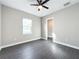 Spacious bedroom with grey flooring, ceiling fan, and an ensuite bathroom at 1793 Lakehill Dr, Winter Haven, FL 33884