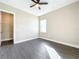 Bright bedroom with grey flooring, ceiling fan, and a large window at 1793 Lakehill Dr, Winter Haven, FL 33884