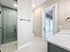 Spa-like bathroom featuring a glass shower, grey tile, and private access to a patio at 1793 Lakehill Dr, Winter Haven, FL 33884