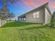 Covered patio and fenced backyard with lush green grass at 1793 Lakehill Dr, Winter Haven, FL 33884