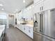 Modern kitchen with white cabinets, stainless steel appliances, and brick backsplash at 1793 Lakehill Dr, Winter Haven, FL 33884