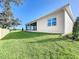 House exterior showcasing a covered patio and landscaping at 1793 Lakehill Dr, Winter Haven, FL 33884