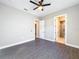 Bright bedroom with grey flooring, ceiling fan, and access to a private bathroom at 1793 Lakehill Dr, Winter Haven, FL 33884