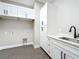 Bright laundry room with white cabinets and a quartz countertop at 1793 Lakehill Dr, Winter Haven, FL 33884