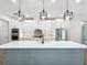 Modern kitchen with white cabinets, large island, and stainless steel appliances at 1793 Lakehill Dr, Winter Haven, FL 33884