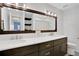 Double vanity bathroom with a large mirror and modern lighting at 1441 S Lake Roy Dr, Winter Haven, FL 33884