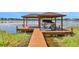Private dock with covered boat lift at 1441 S Lake Roy Dr, Winter Haven, FL 33884