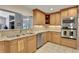 Kitchen features stainless steel appliances and light wood cabinets at 1441 S Lake Roy Dr, Winter Haven, FL 33884