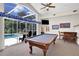Game room with pool table, wet bar, and pool access at 1441 S Lake Roy Dr, Winter Haven, FL 33884