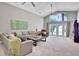 Living room with vaulted ceiling, comfy seating, and lake access at 1441 S Lake Roy Dr, Winter Haven, FL 33884
