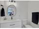 Modern bathroom with white vanity and a contemporary mirror at 1441 S Lake Roy Dr, Winter Haven, FL 33884