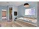 Luxurious bathroom with a large soaking tub and a walk-in shower at 1441 S Lake Roy Dr, Winter Haven, FL 33884