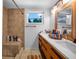 Modern bathroom with a double vanity and a large walk-in shower at 1004 Avenue G Ne, Winter Haven, FL 33881