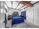 Bedroom with wood beam ceilings, a queen bed, and a large closet at 1004 Avenue G Ne, Winter Haven, FL 33881