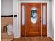 Elegant wood front door with glass accents at 1004 Avenue G Ne, Winter Haven, FL 33881