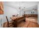 Bright dining room with a rustic wood table and chandelier at 1004 Avenue G Ne, Winter Haven, FL 33881