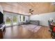 Gathering room with wood-paneled ceiling, and french doors to backyard at 1004 Avenue G Ne, Winter Haven, FL 33881