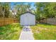 White storage shed with paved pathway at 1004 Avenue G Ne, Winter Haven, FL 33881