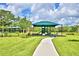 Covered playground with play equipment and shaded seating at 1155 Berry Ln, Davenport, FL 33837