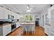 Modern kitchen with white cabinets, butcher block countertops, and island at 319 N Wales Dr, Lake Wales, FL 33853