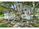 Charming house with wrap-around porch, landscaping, and pond feature at 319 N Wales Dr, Lake Wales, FL 33853