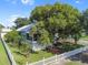 Aerial view of house with large tree and white picket fence at 319 N Wales Dr, Lake Wales, FL 33853