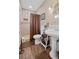 Clean bathroom with a pedestal sink, shower, and updated flooring at 319 N Wales Dr, Lake Wales, FL 33853