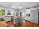 Modern kitchen with white cabinets, butcher block countertops, and island at 319 N Wales Dr, Lake Wales, FL 33853