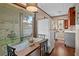 Small kitchen with a refrigerator, dining table, and backyard view at 319 N Wales Dr, Lake Wales, FL 33853