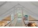 Bright loft bedroom with window and wooden flooring at 319 N Wales Dr, Lake Wales, FL 33853