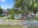 House exterior with white picket fence and large tree at 319 N Wales Dr, Lake Wales, FL 33853
