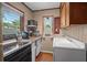 Small kitchen with appliances, and white cabinetry at 319 N Wales Dr, Lake Wales, FL 33853