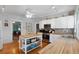 Modern kitchen with white cabinets, butcher block countertops, and island at 319 N Wales Dr, Lake Wales, FL 33853