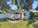White cottage with lattice patio and lush landscaping at 319 N Wales Dr, Lake Wales, FL 33853