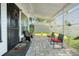 Inviting front porch with seating area and privacy screens at 319 N Wales Dr, Lake Wales, FL 33853