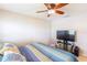 Bedroom with queen-size bed, ceiling fan, and TV at 3200 Citrus Ct, Lake Wales, FL 33898