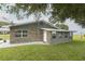 Stone and gray exterior of home with white door at 3200 Citrus Ct, Lake Wales, FL 33898